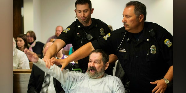 FILE - In this Nov. 10, 2015, file photo, Frazier Glenn Miller Jr., convicted of capital murder, attempted murder and other charges, gestures as Johnson County deputies remove Miller from the courtroom during the sentencing phase of his trial at the Johnson County District Court in Olathe, Kan. (Joe Ledford/The Kansas City Star via AP, Pool, File)