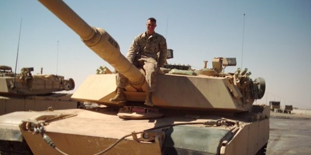 Private First Class Michael Logue on a tank