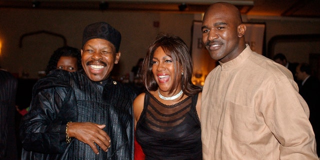 In this Feb. 20, 2003 file photo, Lloyd Price, left, and Mary Wilson, of the Supremes, pose for a photograph with boxer Evander Holyfield during the reception of the 13th Annual Pioneer Awards presented by the Rhythm &amp; Blues Foundation in New York. The New Orleans mainstay and Rock and Roll Hall of Famer has died. Price was known for such hits as "Lawdy Miss Clawdy" and "Stagger Lee." His wife Jackie said he died Monday, May 3, 2021 in New Rochelle, N.Y. 