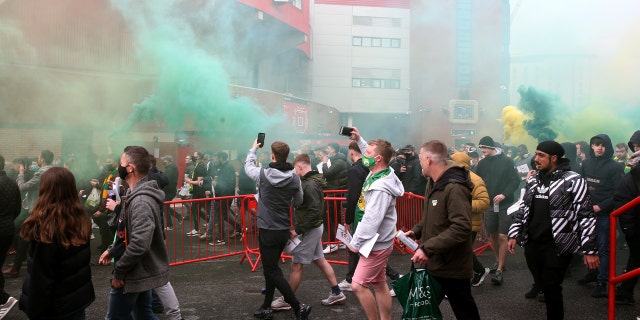 Fans make their way into the ground as they protest against the Glazer family, owners of Manchester United, before their Premier League match against Liverpool at Old Trafford, Manchester. Issue date: Sunday May 2, 2021.