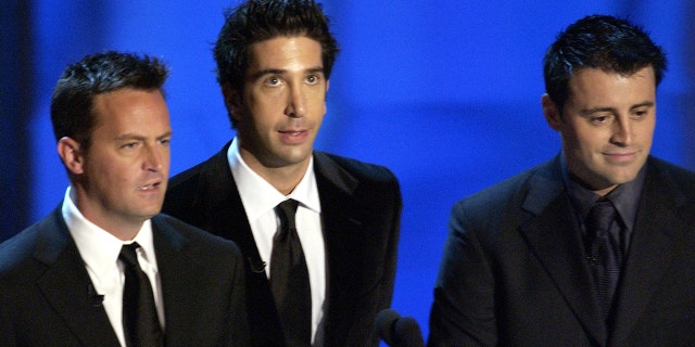 Matthew Perry (left) on stage at the Emmys in 2003 with his fellow ‘Friends’ stars David Schwimmer (center) and Matt LeBlanc (right) to present the award for outstanding supporting actress in a comedy series. (Photo by Ray Mickshaw/WireImage)