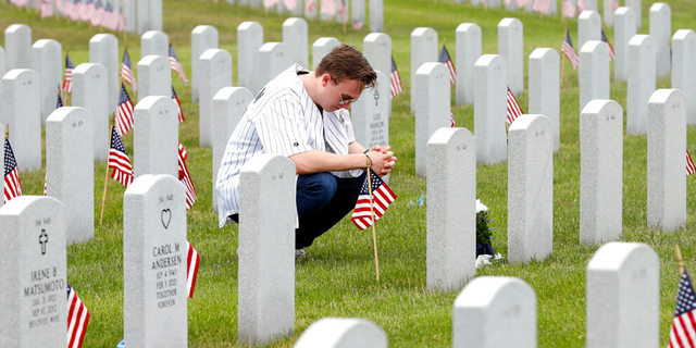 On Memorial Day, a young American pauses to honor the deceased. 