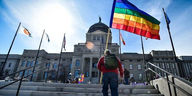 A demonstrator approaches the Montana State Capitol in Helena.