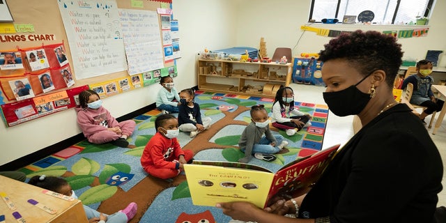 Melissa Jean reads "The Gruffalo" to her son's pre-K class at Phyl's Academy in the Brooklyn borough of New York on March 24. New York City schools will be all in person this fall with no remote options, Mayor Bill de Blasio announced Monday, May 24. (AP)