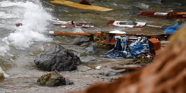 Wreckage and debris from a capsized boat washes ashore at Cabrillo National Monument near where a boat capsized just off the San Diego coast Sunday, May 2, 2021, in San Diego.