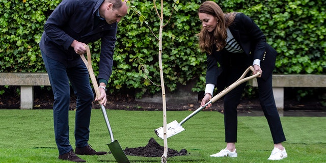 Prince William, Duke of Cambridge and Catherine, Duchess of Cambridge take part in planting a tree during a visit to the University of St Andrews on May 26, 2021, in St Andrews, Scotland. (Photo by Andy Buchanan - WPA Pool/Getty Images)
