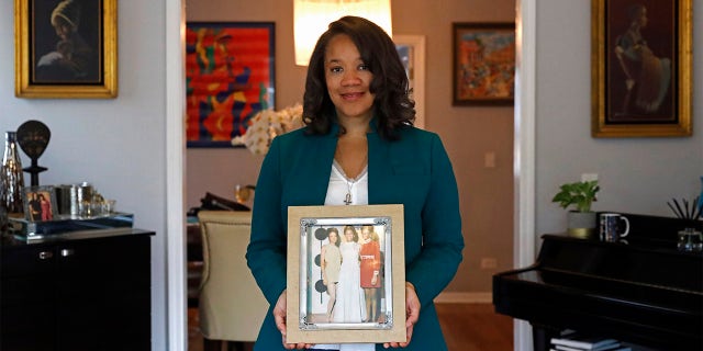 Robin Rue Simmons, alderwoman of Evanston's 5th Ward poses for a portrait holding a photograph of her mother, aunt and grandmother in her home in Evanston, Ill., Friday, April 9, 2021.