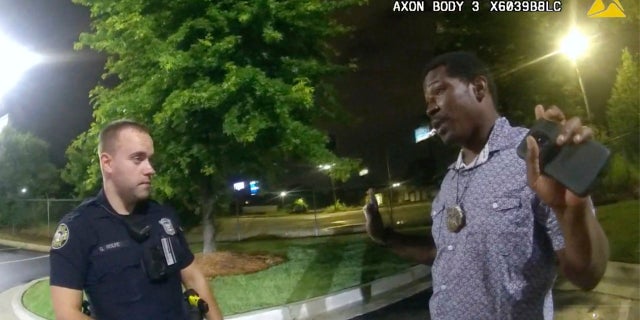 Rayshard Brooks, right, speaks with Officer Garrett Rolfe, left, in the parking lot of a Wendy's restaurant, in Atlanta, on June 12, 2020. (AP/Atlanta Police Department)