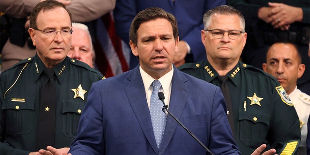 Gov. Ron DeSantis holds a news conference at the Polk County Sheriff's Office in Winter Haven, Fla., on Monday, April 19, 2021, surrounded by law enforcement, legislators, and police union representatives, to sign a bill to create tougher penalties for people who participate in violent protests. (Ricardo Ramirez Buxeda/Orlando Sentinel via AP)