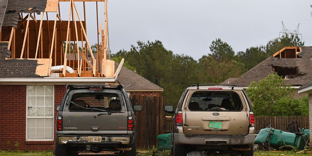 Damaged homes and vehicles are seen along Elvis Presley Drive in Tupelo, Miss., Monday, May 3, 2021.  (AP Photo/Thomas Graning)