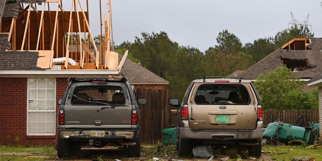 Damaged homes and vehicles are seen along Elvis Presley Drive in Tupelo, Miss., Monday, May 3, 2021. (AP Photo/Thomas Graning)