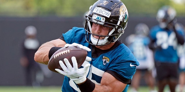 Jaguars tight end Tim Tebow catches a pass during practice on May 27, 2021, in Jacksonville, Florida. (AP Photo/John Raoux)