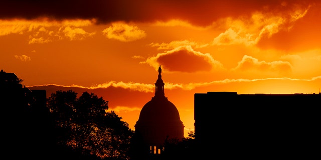 The U.S. Capitol Dome is silhouetted against the rising sun, Friday, April 30, 2021 in Washington. 