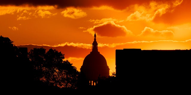 The US Capitol Dome is silhouetted against the rising sun, Friday, April 30, 2021 in Washington. 