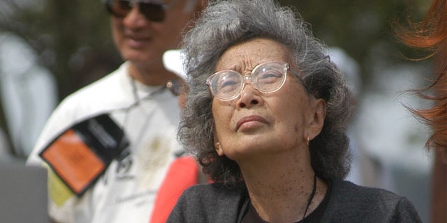 In this file photo taken Sept. 26, 2004, Yuri Kochiyama, of Oakland, Calif., looks at a memorial erected for the inhabitants of a Japanese-American World War II interment camp in Rohwer, Ark. The civil rights activist, whose photograph famously appeared in Life magazine showing her cradling the head of Malcom X moments after he was shot, died of natural causes in her Berkeley, Calif., home June 1, 2014. She was 93. 