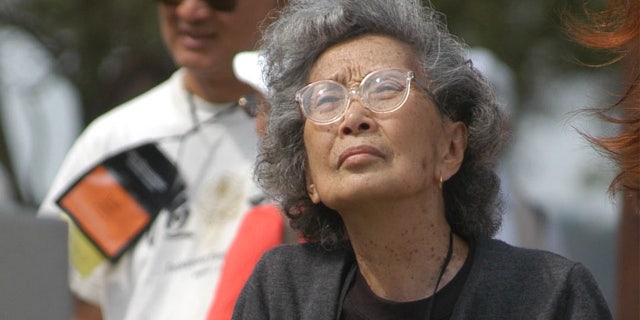 In this file photo taken Sept. 26, 2004, Yuri Kochiyama, of Oakland, Calif., looks at a memorial erected for the inhabitants of a Japanese-American World War II interment camp in Rohwer, Ark. The civil rights activist, whose photograph famously appeared in Life magazine showing her cradling the head of Malcom X moments after he was shot, died of natural causes in her Berkeley, Calif., home June 1, 2014. She was 93.