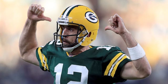 Aaron Rodgers #12 of the Green Bay Packers reacts after throwing a game-winning touchdown against the Dallas Cowboys in the fourth quarter at AT&T Stadium on October 8, 2017 in Arlington, Texas.  