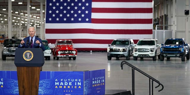 An electric F-150 Lightning (silver) was parked behind President Biden as he made remarks at Ford's Rouge Electric Vehicle Center.