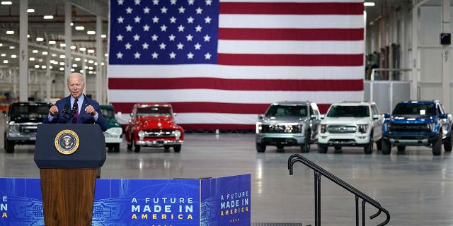 A silver Ford F-150 Lightning was parked alongside previous versions of the pickup.