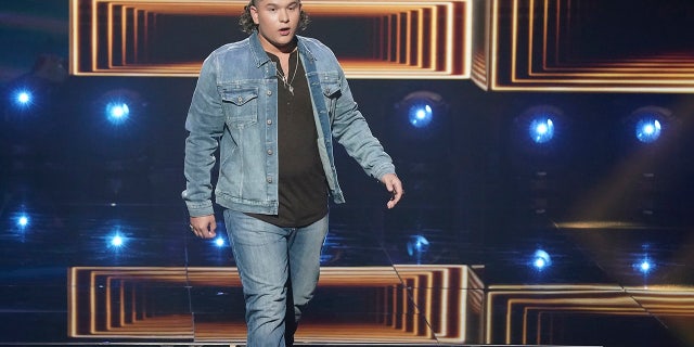 ‘American Idol’ contestant Caleb Kennedy apologized for a video that has surfaced of him allegedly standing next to an individual who appears to wear a Ku Klux Klan hood.