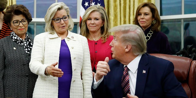 Rep. Liz Cheney, R-Wyo., center, speaks with President Donald Trump during a bill signing ceremony for the Women's Suffrage Centennial Commemorative Coin Act in the Oval Office of the White House in Washington. (AP Photo/Patrick Semansky, File)