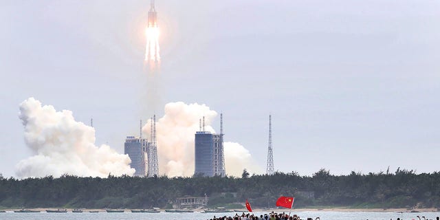 In this photo released by China's Xinhua News Agency, a Long March 5B rocket carrying a module for a Chinese space station lifts off from the Wenchang Spacecraft Launch Site in Wenchang in southern China's Hainan Province. (Jin Liwang/Xinhua via AP)