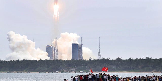 In this photo released by China's Xinhua News Agency, a Long March 5B rocket carrying a module for a Chinese space station lifts off from the Wenchang Spacecraft Launch Site in Wenchang in southern China's Hainan Province. (Jin Liwang/Xinhua via AP)