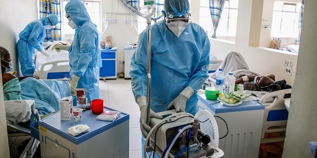April 14, 2021: In this file photo, medical workers tend to coronavirus patients in the COVID-19 intensive care unit at Kenyatta National Hospital, in Nairobi, Kenya..