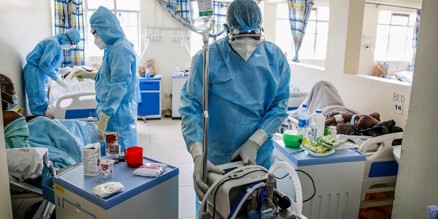 April 14, 2021: In this file photo, medical workers tend to coronavirus patients in the COVID-19 intensive care unit at Kenyatta National Hospital, in Nairobi, Kenya..