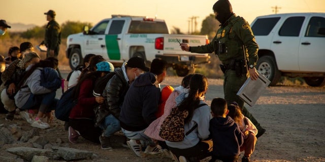 U.S. Customs and Border Protection agents detain migrants found at the southern border from the Yuma, Ariz., sector.