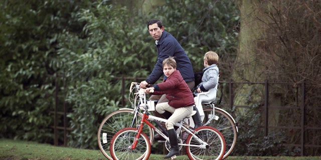 Prince Charles, Prince William And Prince Harry on bikes returning from the stables at Sandringham Estate, in Norfolk.