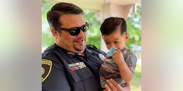 Covington PD officer Matt Holbrook saved 15-month-old Adrian Tovar by giving him back thrusts that dislodged the child's obstructed airway. 