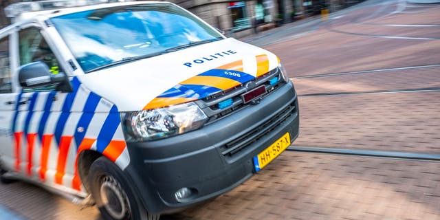 Dutch police car rushing to the scene of an incident in Amsterdam.