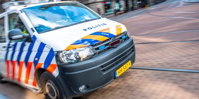 Dutch police car rushing to the scene of an incident in Amsterdam.