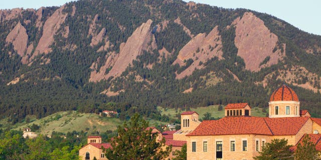 The Flatirons behind a classroom building on the University of Colorado campus in Boulder, Colorado.