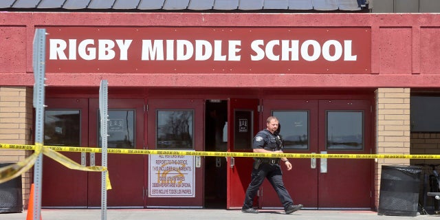 A police officer walks out of Rigby Middle School following a shooting there on Thursday. (AP)