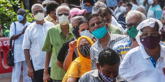 April 26, 2021: In this file photo, people queue up for the coronavirus vaccine in Mumbai, India. 