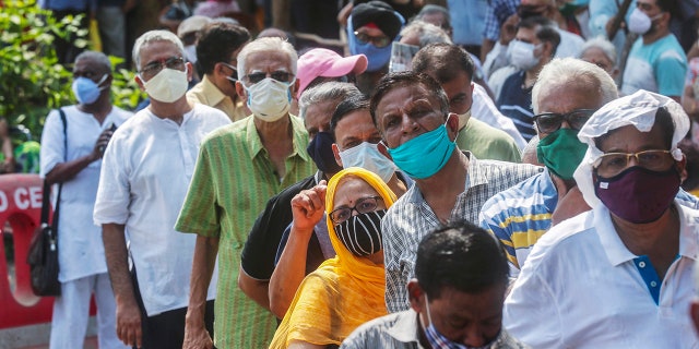 April 26, 2021: In this file photo, people queue up for the coronavirus vaccine in Mumbai, India.