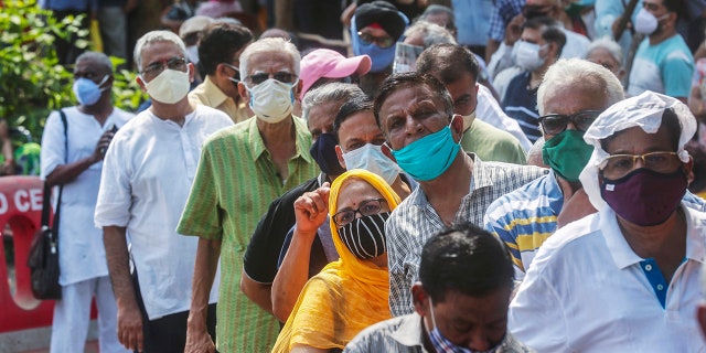 April 26, 2021: In this file photo, people queue up for the coronavirus vaccine in Mumbai, India. 