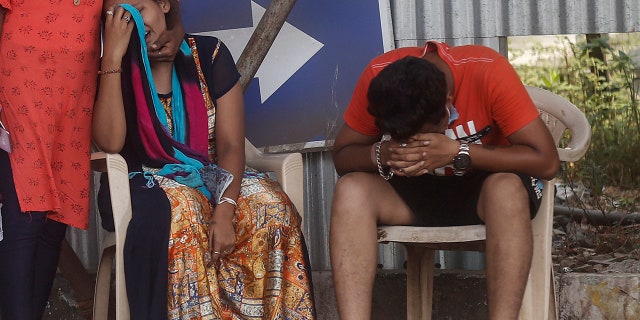 May 3, 2021: Relatives of a person who died of COVID-19 mourn outside a field hospital in Mumbai, India.