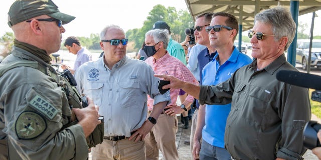 Rep. Michael McCaul (right) speaks to Border Patrol agents at the Rio Grande Valley in Texas.