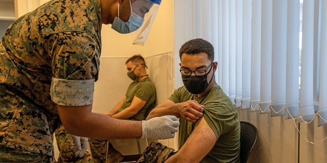 KIN, JAPAN - APRIL 28: A United States Marine prepares to receive the Moderna coronavirus vaccine at Camp Hansen on April 28, 2021 in Kin, Japan.  (Photo by Carl Court/Getty Images)