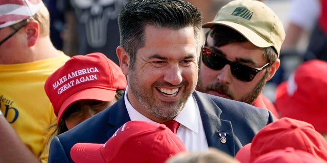 FILE - In this Sept. 22, 2020 file photo, Sean Parnell walks through people gathered at a campaign rally for President Donald Trump at the Pittsburgh International Airport in Moon Township, Pa. (AP Photo/Keith Srakocic, File)