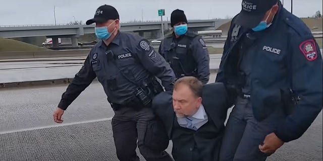 Pastor Artur Pawlowski being arrested by Calgary police in the middle of a highway on his way home from church on May 8, 2021. (Photo courtesy Artur Pawlowski)
