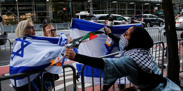 A pro-Palestinian supporter argues with Israeli supporters during a protest near the Israeli Consulate in New York City on Tuesday. (Reuters)