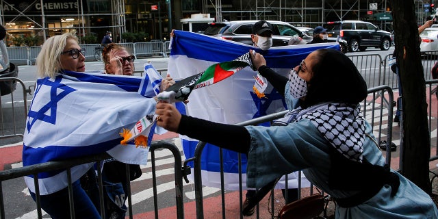 A pro-Palestinian supporter argues with Israeli supporters during a protest near the Israeli Consulate in New York City on Tuesday. (Reuters)