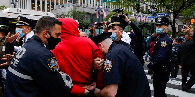 NYPD officers detain a pro-Palestinian supporter near the Israeli Consulate on Tuesday. (Reuters)