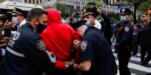 NYPD officers detain a pro-Palestinian supporter near the Israeli Consulate on Tuesday. (Reuters)