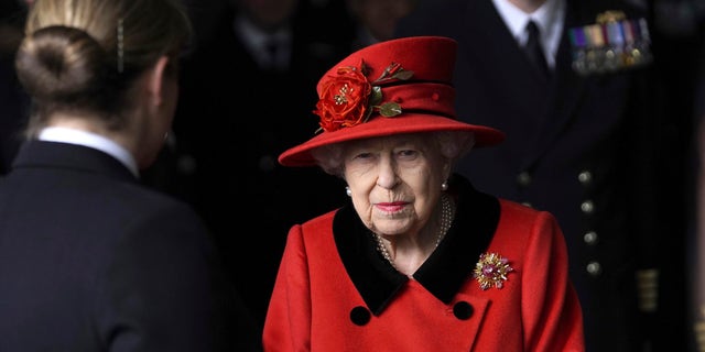 Britain's Queen Elizabeth II smiles during a visit to HMS Queen Elizabeth at HM Naval Base, ahead of the ship's maiden deployment, in Portsmouth, England, Saturday May 22, 2021. The monarch wore a brooch reportedly given to her by the late Prince Philip for the outing. (Steve Parsons/Pool Photo via AP)