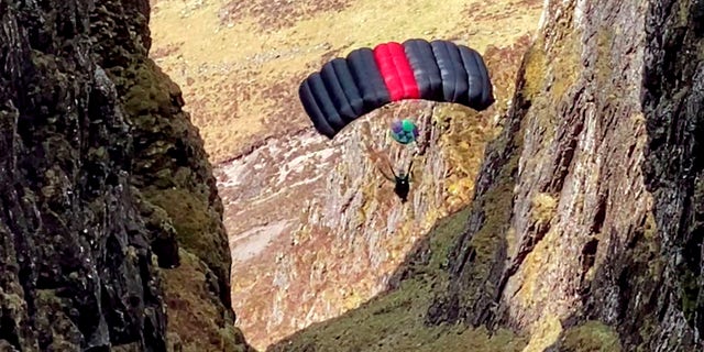 Nick Cowie filmed a base jumper leap off Aonach Eagach in Glen Coe, Scotland, and parachute through the narrow ridge.